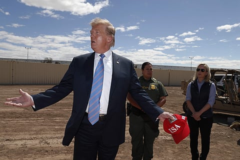 President Donald Trump visits a new section of the border wall with Mexico in Calexico, Calif., Friday April 5, 2019. Gloria Chavez with the U.S. Border Patrol, center, and Homeland Security Secretary Kirstjen Nielsen listen. (Photo: AP)