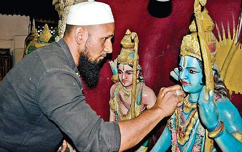 Ahead of Ramanavami festival, which falls on April 14, Saddam Hussein cleans the idols kept at the Ram Mandir in Rajajinagar on Monday. | (Shriram BN| EPS)
