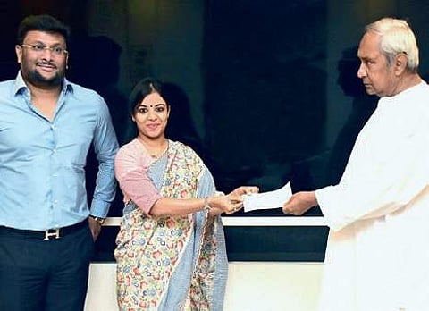 Directors of Falcon Marine Exports Pvt Ltd Parthajeet Mohanty and Priyanka Mohanty handing over the cheque to CM Naveen Patnaik