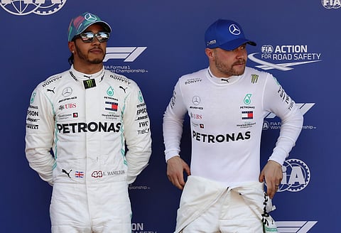 Mercedes driver Valtteri Bottas of Finland, right, pole position, is flanked by his teammate Lewis Hamilton of Britain, second fastest time, after the qualifying session at the Barcelona Catalunya racetrack in Montmelo. (Photo | AP)