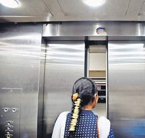 A sticker pasted above the lift entrance at Vikasa Soudha | nagaraja gadekal