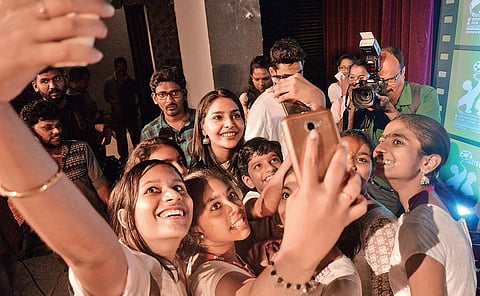 Children taking a selfie with actor Aishwarya Lakshmi at the inaugural function. Vincent Pulickal