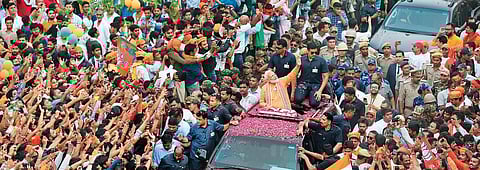 Prime Minister Narendra Modi waves to the crowd during a mega roadshow in Varanasi on Thursday. He is seeking re-election to Parliament from this temple city of Uttar Pradesh . (Photo |AP)