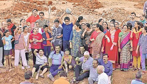 Residents of Girinagar, including children and women, stage a protest against the construction of a police station at a playground, in Bengaluru on Friday | express