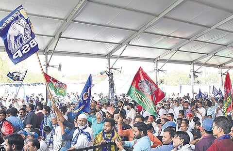 Supporters wave BSP and Samawadi Party flags at a rally by BSP president Mayawati in New Delhi on Friday | Parveen Negi