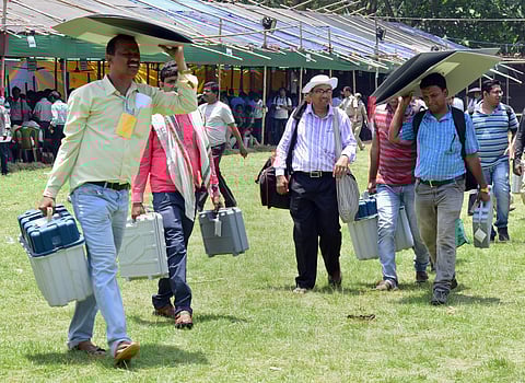 Polling officials leave after collecting election materials from the distribution centre on the eve of sixth phase of Lok Sabha polls in West Midnapore Saturday. (Photo | PTI)
