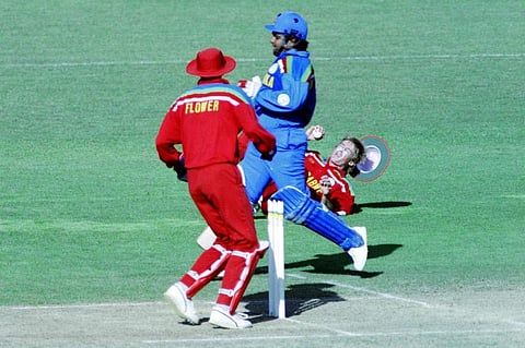 Zimbabwe's Wayne James (L) falls to the ground whilst trying to run out Sri Lanka's Arjuna Ranatunga (C) during the World Cup Cricket match between Zimbabwe and Sri Lanka on February 23, 1992 in New Plymouth. (Photo | AFP)