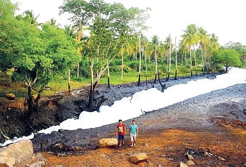Locals walk past the stinking Byramangala lake which started frothing again this week | Pandarinath B