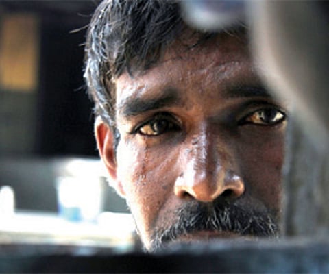 A file photo of Vijayakumar speaking to ‘Express’ through the window on the door of the rehabilitation centre for beggars in the city.(Photo | EPS)