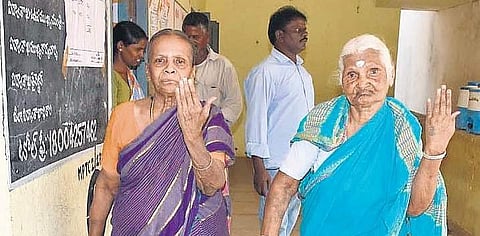 Two elderly women display their inked fingers after casting their votes in Armoor mandal in Nizamabad district on Tuesday. (Photo | EPS)