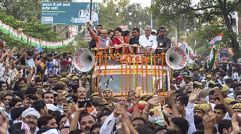 Congress General Secretary Priyanka Gandhi Vadra along with the party candidate Ajay Rai and Chhattisgarh CM Bhupesh Singh Baghel during a roadshow for the Lok Sabha polls in Varanasi. (Photo | PTI)