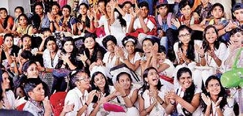 Children clap to a song performed by Jassie Gift, a music composer and playback singer who arrived for the 'Meet the Artist' session held as part of ICFFK at Kairali theatre Vincent Pulickal