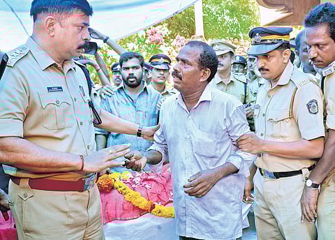 Chandran, husband of Lekha, arriving to pay last respects to the mortal remains of his wife under police protection at Marayimuttom in Thiruvananthapuram | Pics: vincent Pulickal