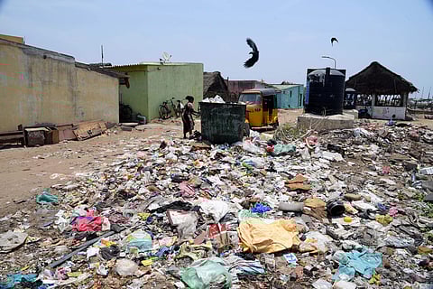 Locals strive hard to tackle the stench emanating from garbage that regularly pile-up at Urur Olcott Kuppam. (Photo | R Satish Babu, EPS)