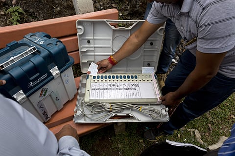 A polling officer checks an electronic voting machine before moving towards his allotted booth in Dharmsala, India, Friday, May 17, 2019. | AP
