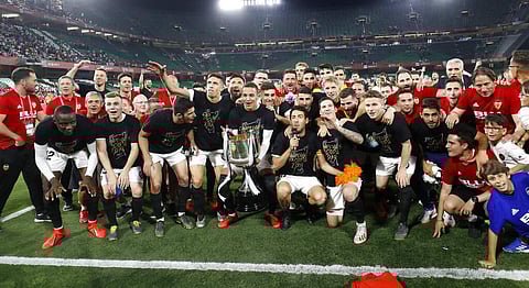 Valencia players celebrate with the trophy after winning the Copa del Rey soccer match final between Valencia CF and FC Barcelona at the Benito Villamarin stadium in Seville. (Photo | AP)