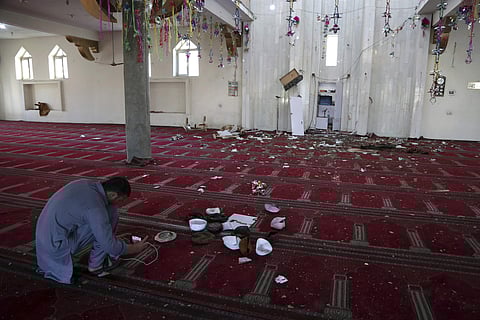 An Afghan Journalist take a photo inside a mosque after a bomb explosion during Friday prayer on the outskirts of Kabul. (Photo | AP)