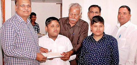 Delhi minister Satyendar Jain with one of the awardees on Tuesday | GOVT sources