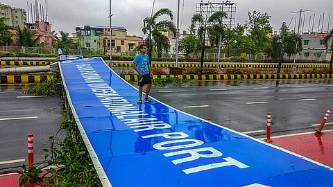 A wind uprooted signage lies on the road after Cyclone Fani made landfall in Bhubaneswar Friday. (Photo | PTI)