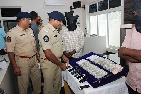 Mangalagiri police with seized cash and mobile phones | Express