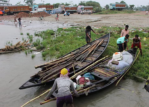 Fishermen drag a boat to the bank of River Hooghly at Santipur following an alert by authorities after Cyclone Fani made its landfall in Odisha in Nadia district of West Bengal Friday. (Photo | PTI)