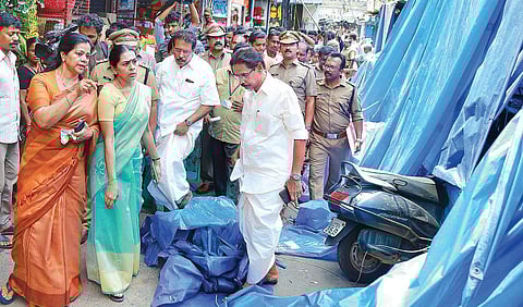 Corporation workers removing the unauthorised extension from shops at Broadway using an iron cutter.