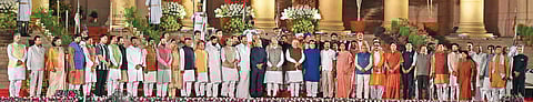 Prime Minister Narendra Modi and members of his council of ministers pose for a group photo with President Ram Nath Kovind shortly after they took their oath of office and secrecy at a ceremony in the forecourt of Rashtrapati Bhavan, in New Delhi on Thurs