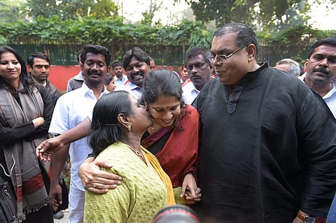 A file image of DMK MP Kanimozhi celebrates with her husband G Aravindan and mother Rajathi Ammal after she was acquitted by a special court in the 2G scam case. (Photo| PTI)