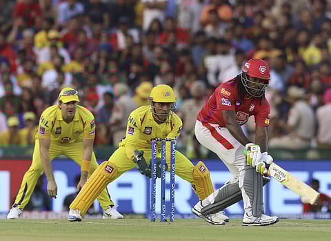 KXIP's Chris Gayle plays a shot against CSK as MS Dhoni and Shane Watson watch in Mohali. (Photo | AP)