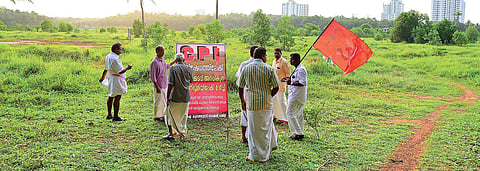 CPI workers installing a flex board protesting the reclamation of 15 acres of paddy field at Manakkakadavu, in Kunnathunadu village, violating the Kerala Paddy and Wetland Conservation Act on Monday. According to the local CPI leaders, the land has been r
