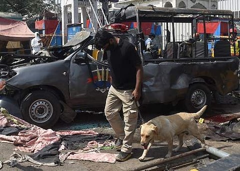 Pakistani security officials examine the site of a bomb blast outside a Sufi shrine in Lahore on May 8, 2019. A blast at one of Pakistan's oldest and most popular Sufi shrines killed at least five people and wounded 24 in the eastern city of Lahore May 8,