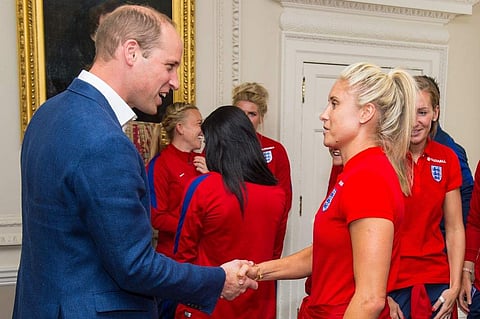 Britain's Prince William, Duke of Cambridge, (L) shakes hands with England women's football team captain Steph Houghton. (Photo | AFP)