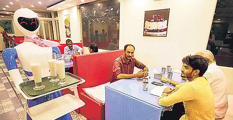 The humanoid serves milkshakes at Upahara Darshini restaurant in Shivamogga | Shimoga Nandan