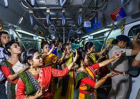 Artists perform in a running metro train to mark the birth anniversary celebrations of Nobel laureate Rabindranath Tagore in Kolkata. (Photo | PTI)