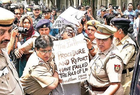 Police officers detain a demonstrator during a protest against the clean chit to CJI Ranjan Gogoi in a case of sexual harassment | parveen negi