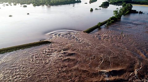 In this aerial image provided by Yell County Sheriff's Department water rushes through the levee along the Arkansas River Friday in Dardanelle, Ark. (Photo | AP)