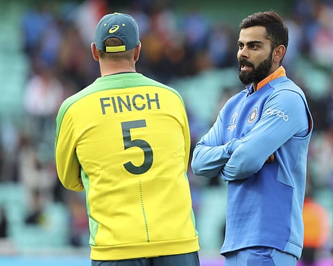 India's captain Virat Kohli, right, talks to Australia's captain Aaron Finch during the presentation ceremony after the Cricket World Cup match between Australia and India at The Oval. (Photo | AP)
