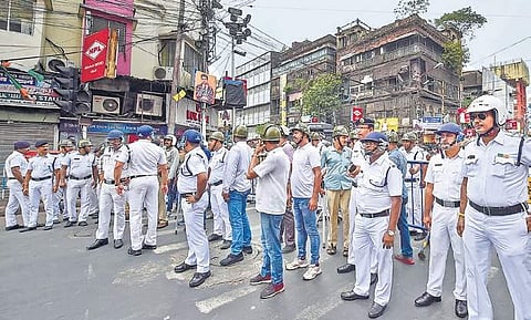 Police personnel stand guard as BJP workers hold a demonstration to protest against the killing of party workers in West Bengal on Sunday | PTI