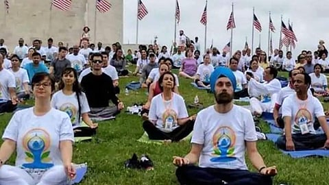 People meditating at the Washington monument for International Yoga Day. (Photo | PTI)