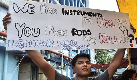Junior doctors hold placards during a demonstration in Kolkata (Photo | PTI)