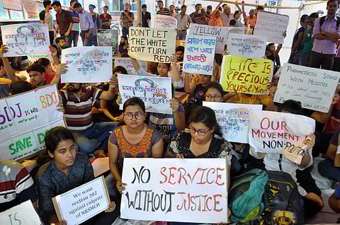 Junior doctors hold placards during their strike in protest against an attack on an intern doctor at Nil Ratan Sircar Medical College and Hospital in Kolkata on 14 June 2019. (Photo | PTI)