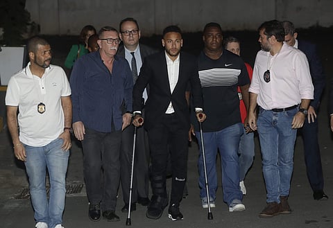 Using crutches because of an injured right ankle, Brazil's soccer player Neymar leaves a police station where he answered questions about rape allegations against him in Sao Paulo, Brazil. (Photo | AP)