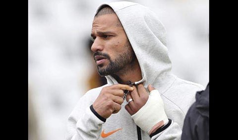 India's Shikhar Dhawan is seen with his left hand covered with a cast during team's training session ahead of their Cricket World Cup match against New Zealand at Trent Bridge in Nottingham. (Photo | AP)