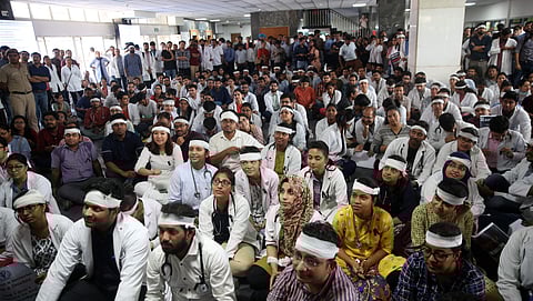 Members of Resident Doctors Association RDA of AIIMS wearing bandages on their heads protest to show solidarity with their counterparts in West Bengal who stopped work on Tuesday protesting against the assault on their colleagues in New Delhi on Friday Ju