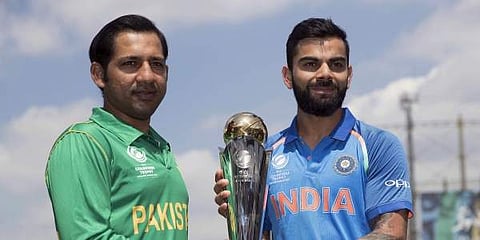 India's captain Virat Kohli, right, and Pakistan's captain Sarfraz Ahmed pose for a picture with the trophy at the Oval cricket ground in London. | AP