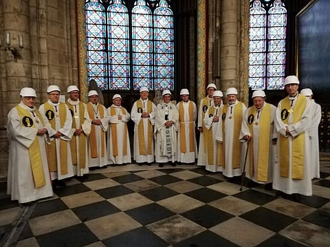 The Archbishop of Paris Michel Aupetit (C) poses with other members of the clergy following the first mass in a side chapel, two months to the day after a devastating fire engulfed the Notre-Dame de Paris cathedral, on June 15, 2019, in Paris. (Photo | AF
