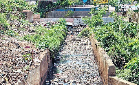 Garbage clogging a drain in Ashok Nagar near the railway station. (Photo | EPS)