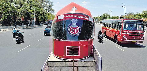 City police display the model of a helmet on Kamarajar Salai near Anna Square as a part of their awareness campaign | D SAMPATHKUMAR