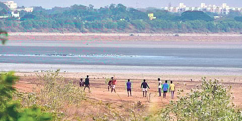 Children playing on the bed of dry Red Hills lake | p jawahar