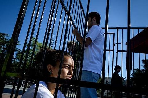 Teenagers are seen in a cage during a protest of international labor groups, civil society and students against the policy of migrant family separation along the US-Mexico border on June 17, 2019 in front of the United Nations offices in Geneva. (Photo |